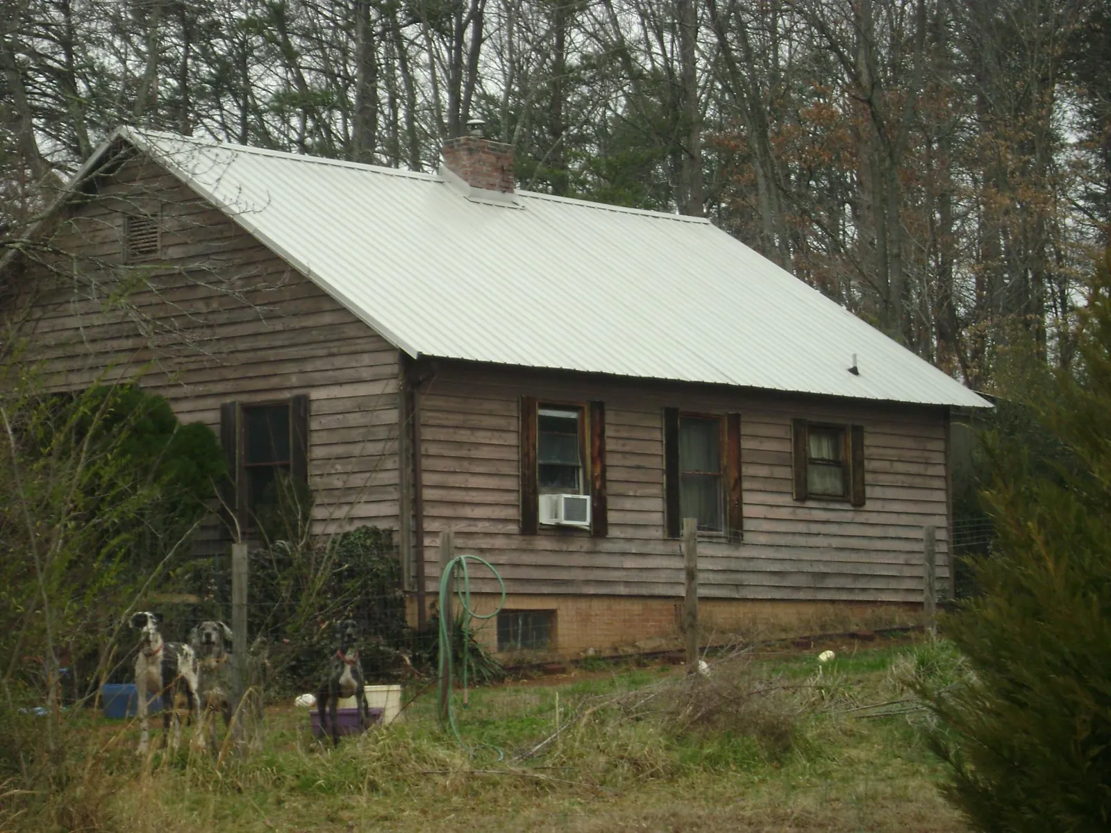 White metal roof on an old wood sided farmhouse, from a Metal Roof Installation job in Lugoff